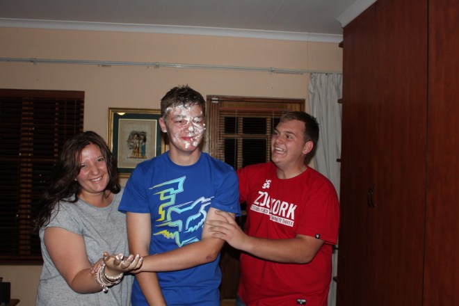 Jared smearing cream all over the birthday boy's face...
